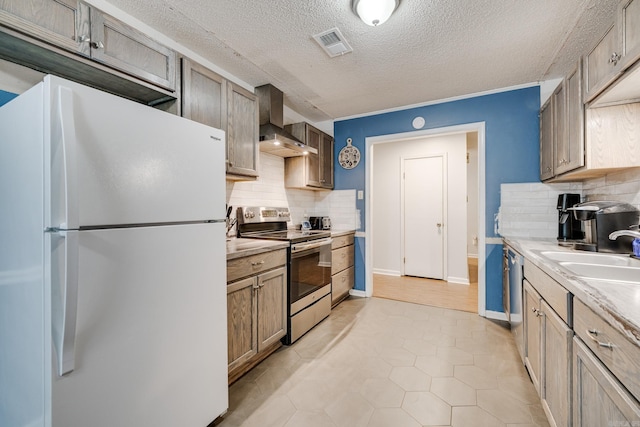 kitchen featuring a textured ceiling, appliances with stainless steel finishes, tasteful backsplash, light hardwood / wood-style flooring, and wall chimney range hood