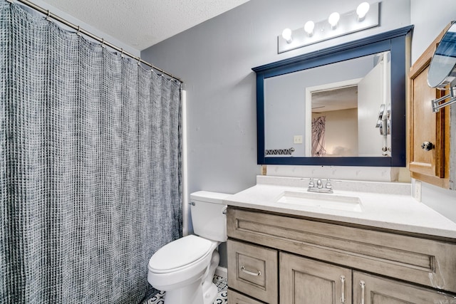 bathroom featuring a textured ceiling, toilet, and vanity