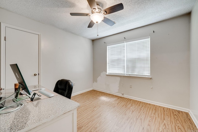 office space with a textured ceiling, light wood-type flooring, and ceiling fan