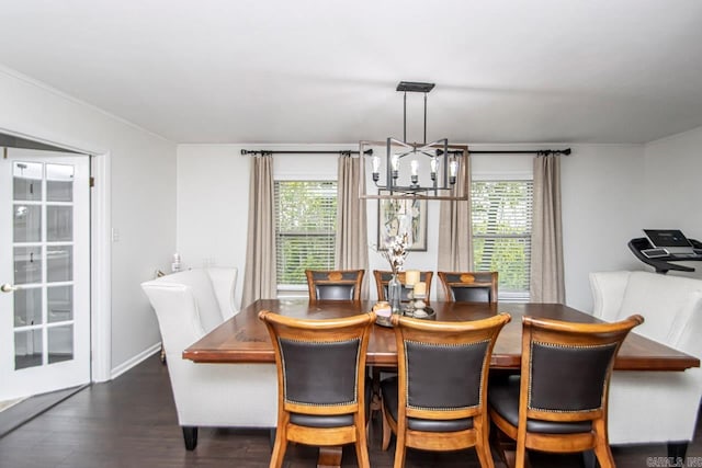 dining space featuring a notable chandelier, dark wood-type flooring, and a wealth of natural light