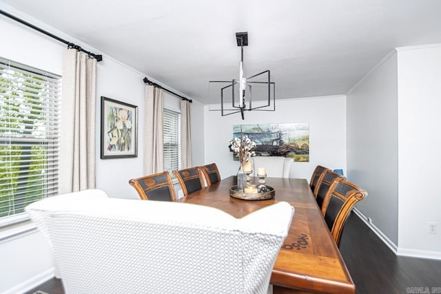 dining area featuring crown molding, hardwood / wood-style flooring, and a chandelier