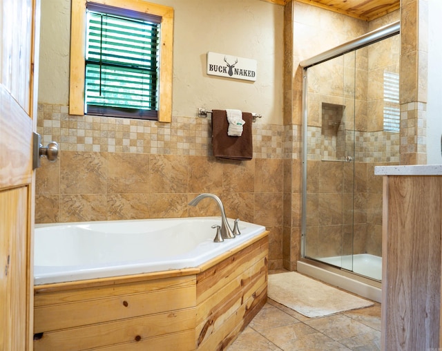 bathroom featuring tile walls, tile patterned floors, and separate shower and tub