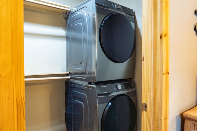 washroom featuring stacked washing maching and dryer