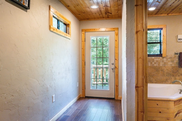 doorway to outside with dark wood-type flooring, ornamental molding, and wood ceiling