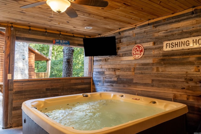 misc room featuring a hot tub, wooden walls, wood ceiling, and ceiling fan