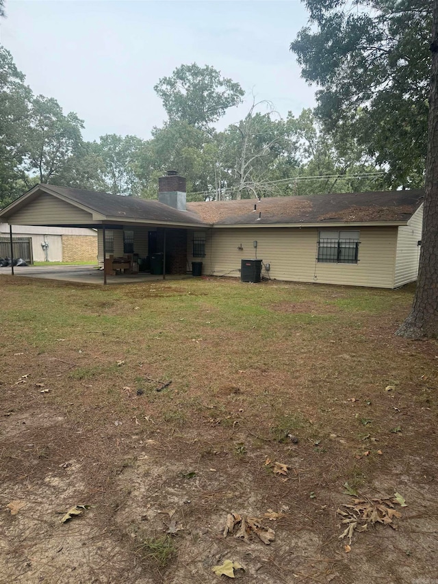 rear view of house featuring central air condition unit and a patio