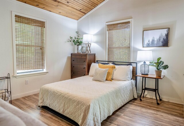 bedroom featuring wooden ceiling, ornamental molding, and wood-type flooring