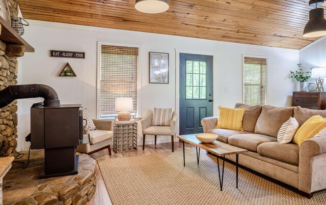 living room with ornamental molding, light hardwood / wood-style floors, and wood ceiling