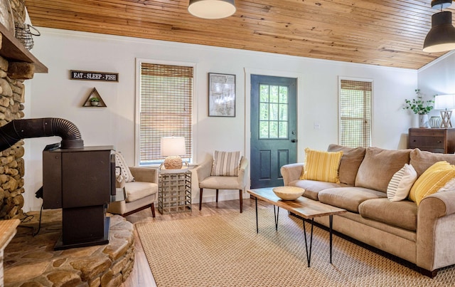 living room with ornamental molding, hardwood / wood-style floors, and wooden ceiling