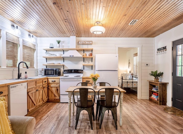 kitchen featuring custom exhaust hood, light hardwood / wood-style flooring, wooden ceiling, and white appliances