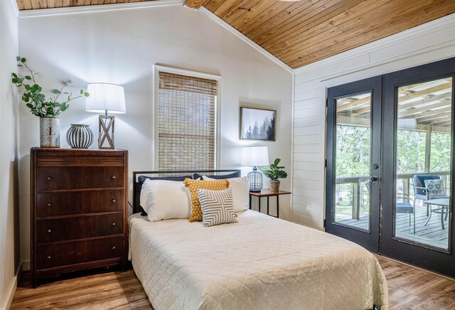 bedroom with light wood-type flooring, vaulted ceiling, wooden ceiling, and access to exterior