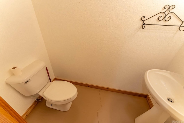 bathroom with sink, toilet, and tile patterned floors