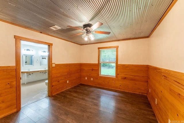 unfurnished room featuring wood walls, ornamental molding, hardwood / wood-style flooring, ceiling fan, and wood ceiling