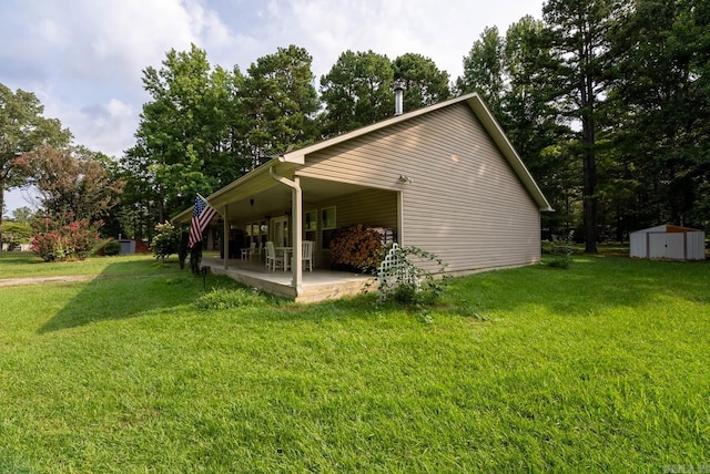 view of home's exterior with a lawn and a storage unit