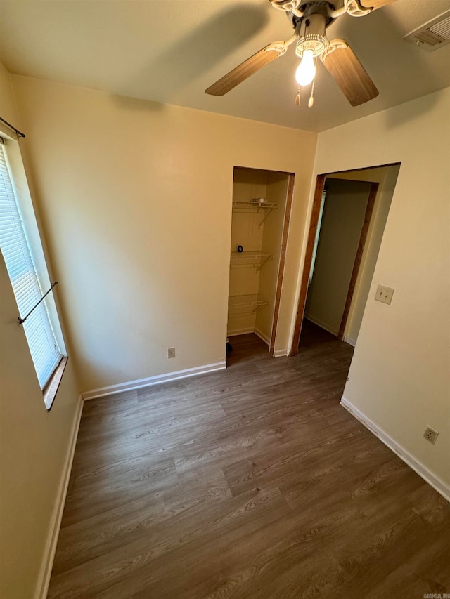 unfurnished bedroom with dark hardwood / wood-style flooring and ceiling fan