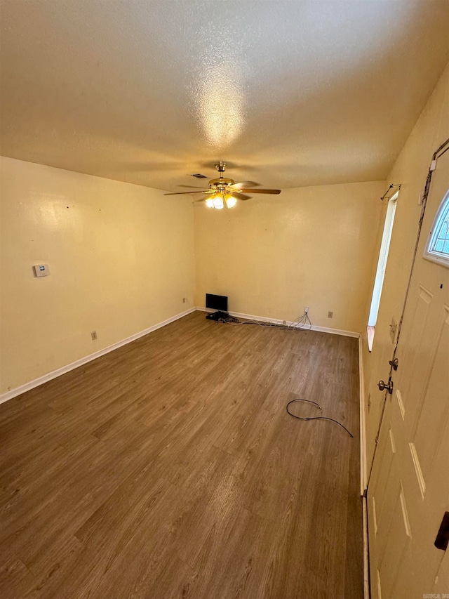 interior space featuring a textured ceiling, ceiling fan, and hardwood / wood-style flooring