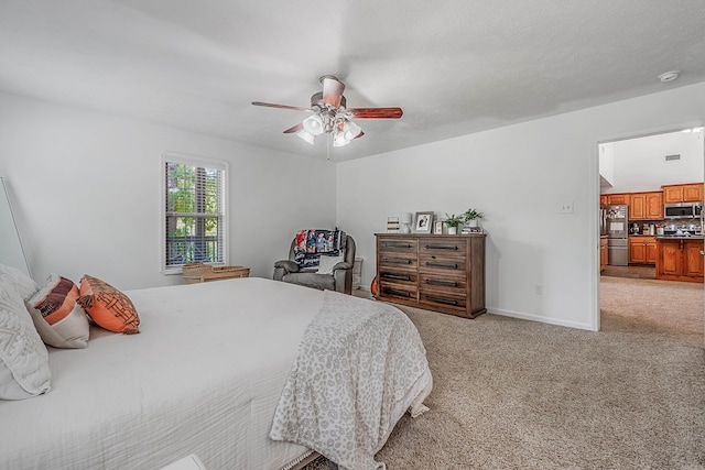 carpeted bedroom with ceiling fan and stainless steel refrigerator