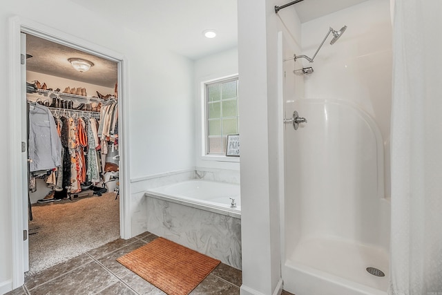 bathroom featuring plus walk in shower and tile patterned floors