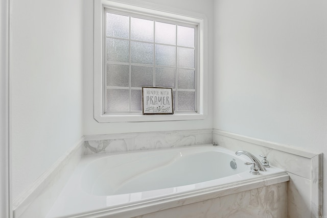 bathroom featuring tiled tub