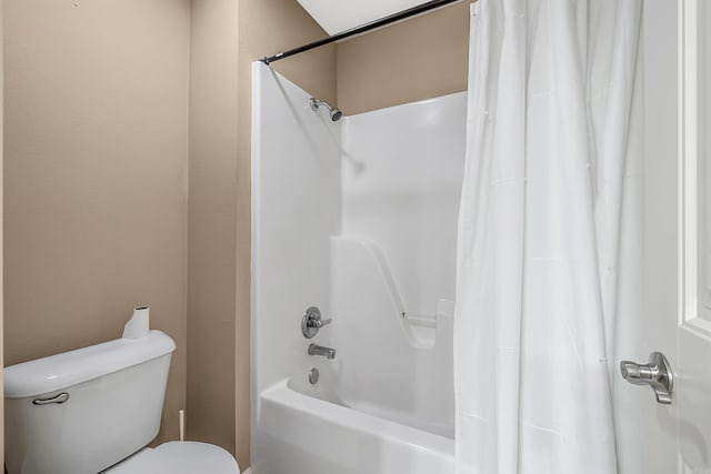 bathroom featuring shower / tub combo and toilet