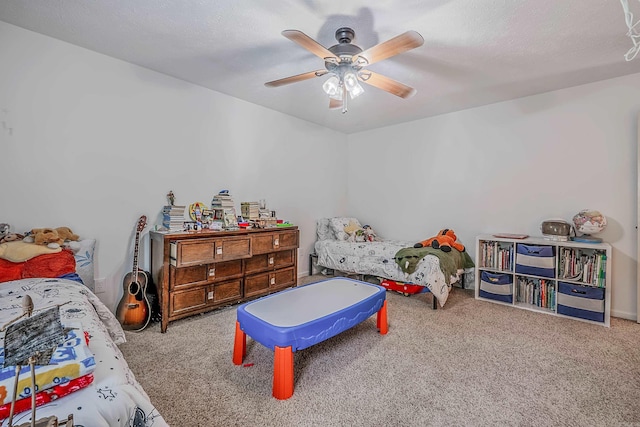 carpeted bedroom featuring ceiling fan and a textured ceiling