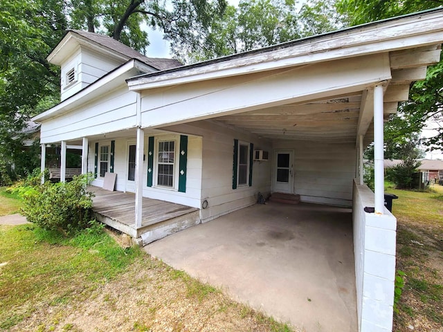 187 N Monroe St, Piggott, AR 72454 - view of front of house with a porch and a wall unit AC