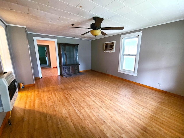 187 N Monroe St, Piggott, AR 72454 - interior space with crown molding, ceiling fan, a wall unit AC, heating unit, and light hardwood / wood-style floors