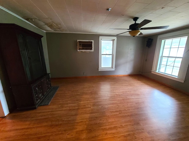 187 N Monroe St, Piggott, AR 72454 - spare room featuring hardwood / wood-style floors, a wall mounted air conditioner, and ceiling fan