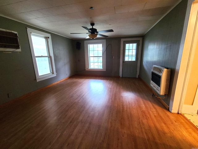 187 N Monroe St, Piggott, AR 72454 - unfurnished living room with heating unit, hardwood / wood-style flooring, ornamental molding, and ceiling fan