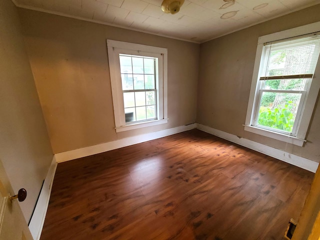 187 N Monroe St, Piggott, AR 72454 - spare room with ornamental molding and dark hardwood / wood-style floors