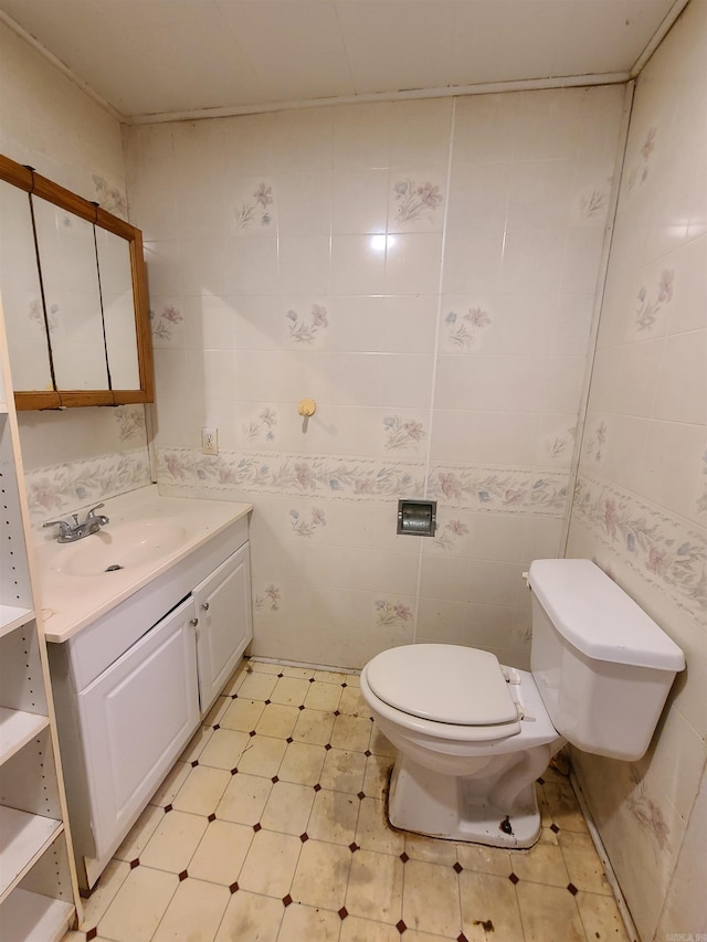 187 N Monroe St, Piggott, AR 72454 - bathroom with vanity, toilet, and tile walls
