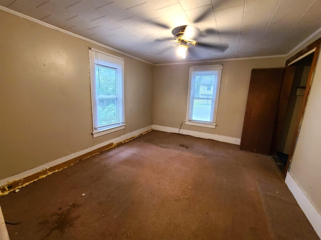187 N Monroe St, Piggott, AR 72454 - unfurnished bedroom with crown molding, ceiling fan, and dark carpet