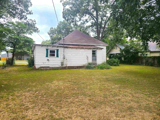 187 N Monroe St, Piggott, AR 72454 - rear view of house featuring a lawn