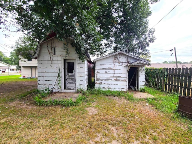 187 N Monroe St, Piggott, AR 72454 - exterior space featuring a storage shed and a yard