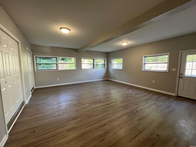 interior space with beamed ceiling and dark hardwood / wood-style flooring