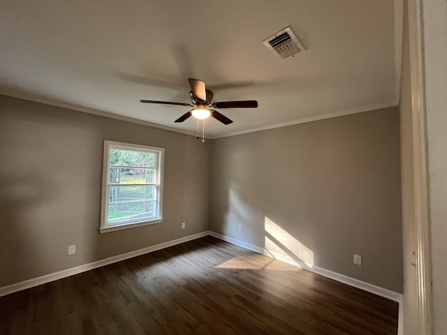 spare room with dark wood-type flooring, ceiling fan, and crown molding