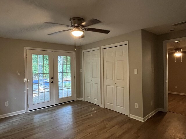 interior space with dark hardwood / wood-style flooring, french doors, and ceiling fan