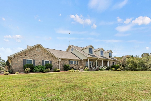 new england style home with brick siding and a front yard