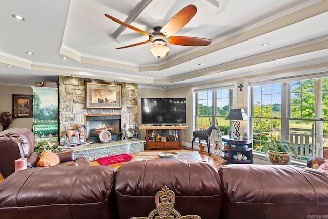 living area with a fireplace, recessed lighting, a raised ceiling, ornamental molding, and ceiling fan