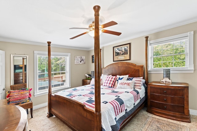 carpeted bedroom with baseboards, a ceiling fan, and crown molding