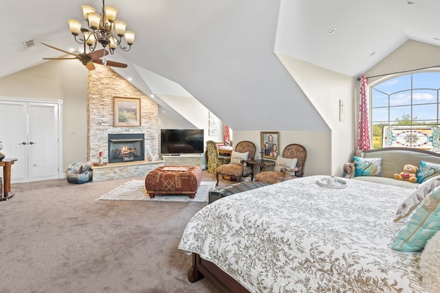 carpeted bedroom with visible vents, vaulted ceiling, a stone fireplace, and an inviting chandelier