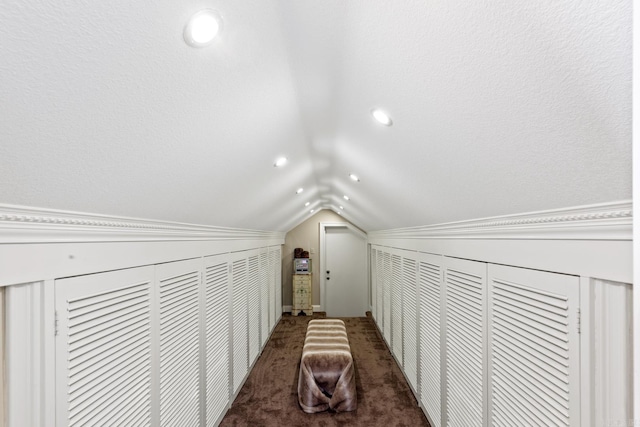 corridor featuring carpet flooring and vaulted ceiling