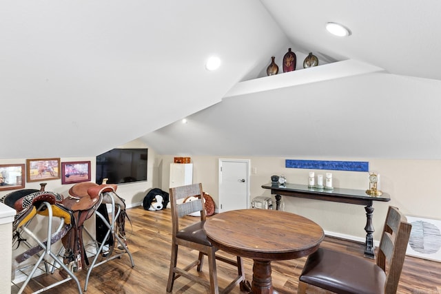 dining area featuring vaulted ceiling, wood finished floors, and recessed lighting