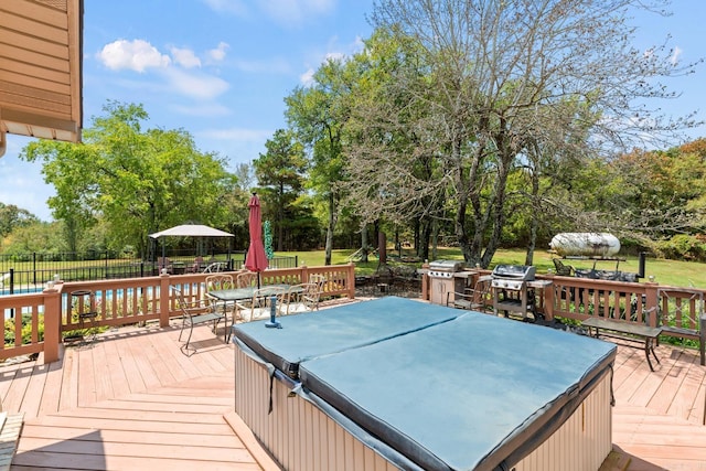 wooden deck with outdoor dining space, a grill, fence, and a hot tub