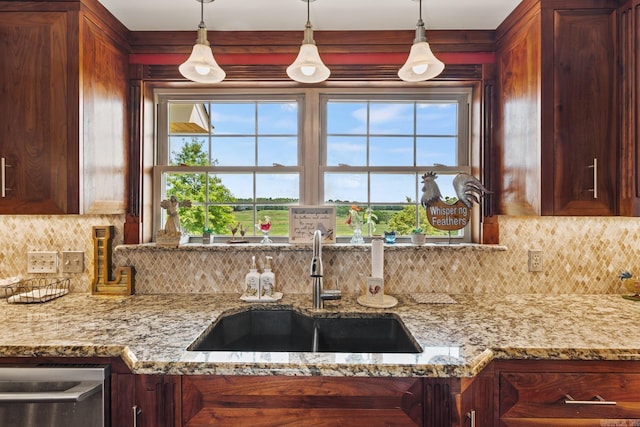 kitchen with stainless steel dishwasher, plenty of natural light, tasteful backsplash, and a sink