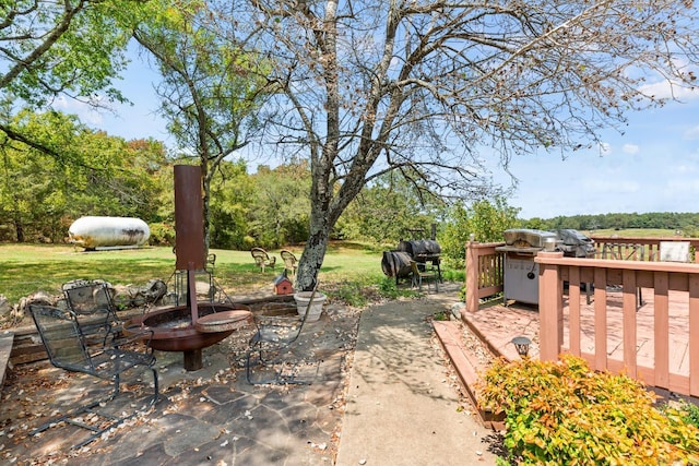 view of yard featuring an outdoor fire pit and a wooden deck