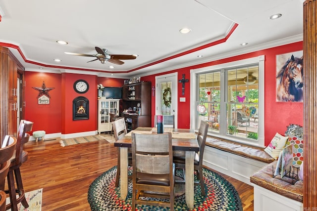 dining area with ceiling fan, ornamental molding, and wood finished floors