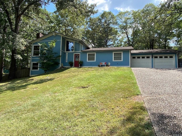 view of front facade featuring a garage, driveway, a chimney, and a front yard