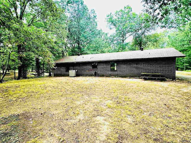 rear view of property with a lawn