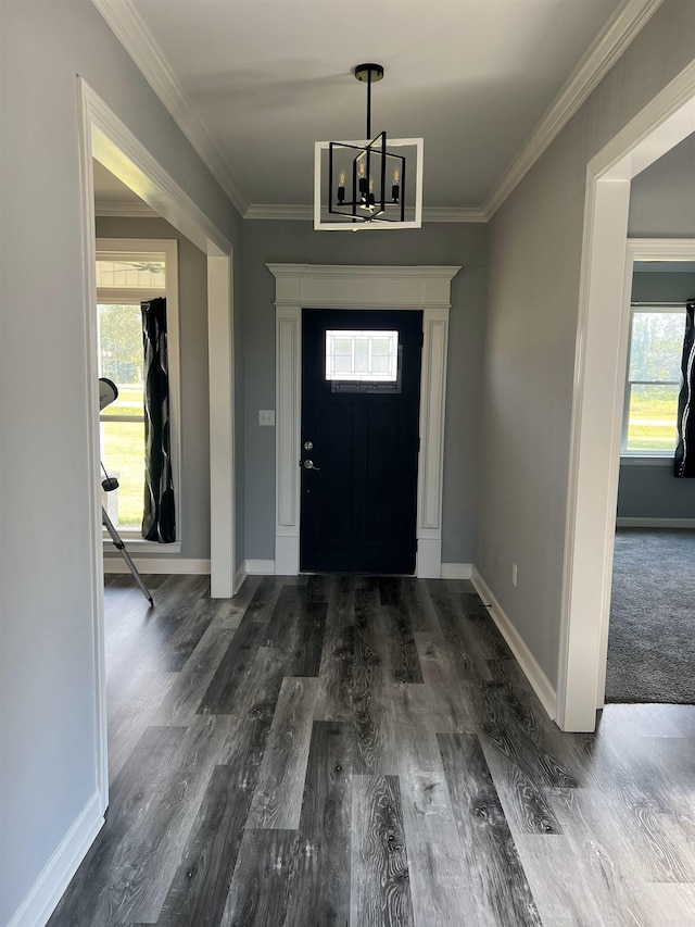 carpeted foyer entrance featuring a wealth of natural light, an inviting chandelier, and crown molding